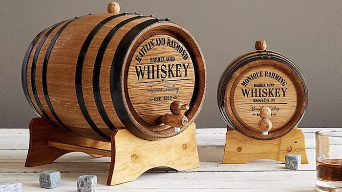 good gifts for dad one big and one smaller wooden whiskey barrel placed on wooden surface whiskey glasses