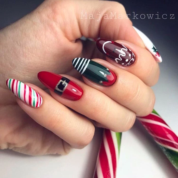 green and red nail polish on long almond nails christmas nails 2020 different decoration on each nail inspired by christmas