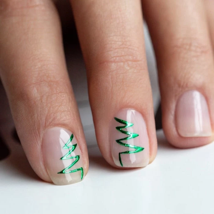 green christmas tree outline on middle and ring fingers christmas nails 2020 minimalistic nail design on short squoval nails