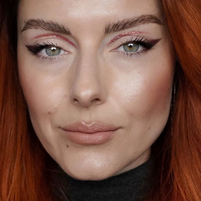 green eyed woman with thick eyebrows long red wavy hair how to do a cat eye with pink glitter