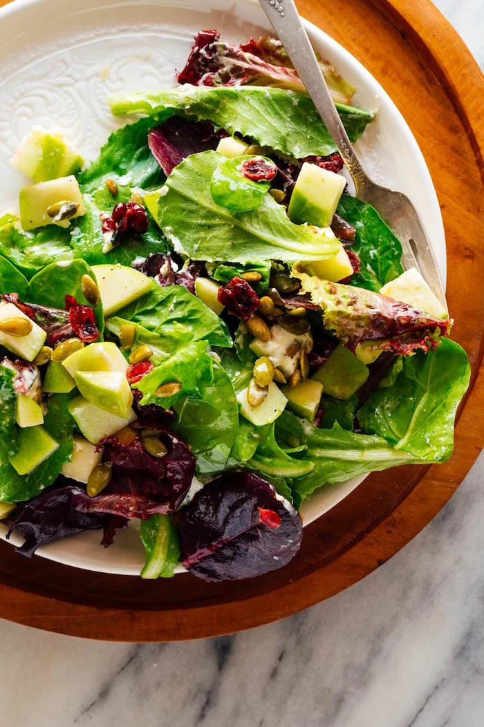 green salad spinach and apples salad christmas food ideas with pine nuts and dried cranberries