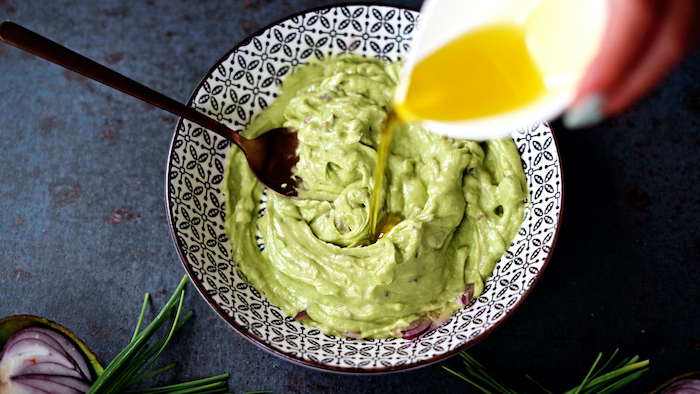 green sauce made with onion olive oil inside black and white ceramic bowl thanksgiving side dish recipes with spoon on the side