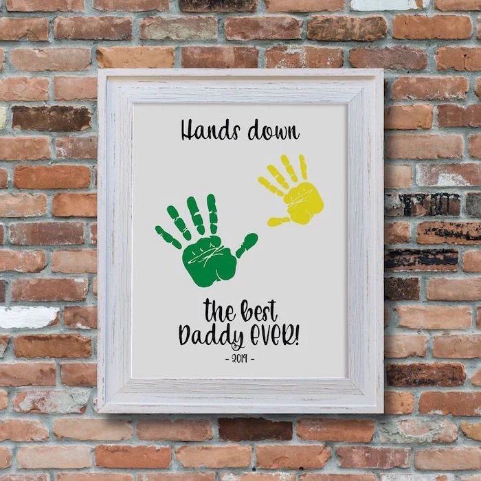 hands down the best daddy ever with two handprints christmas gifts for dad poster hanging on brick wall