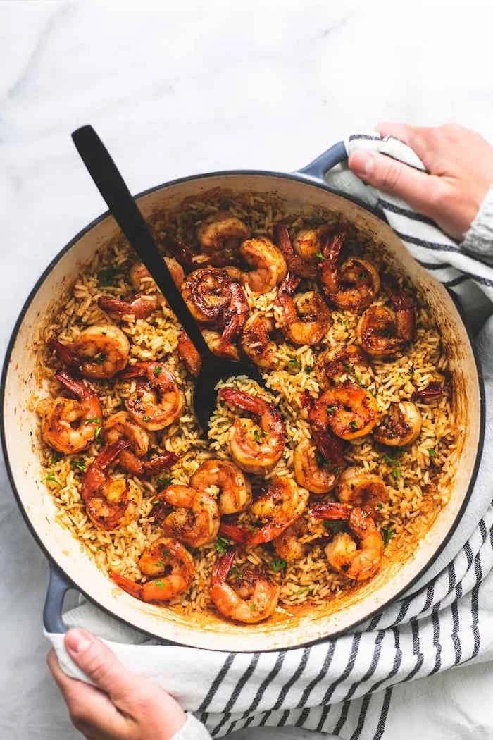 how long to cook shrimp one pan shrimp rice cooked in skillet stirred with black spoon placed on marble surface