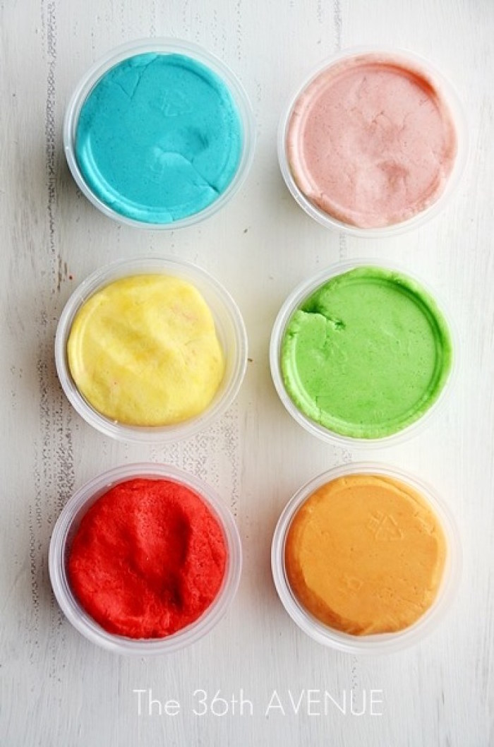 how to make play dough with kool aid things to do with kids at home six plastic cups with blue pink yellow green red orange dough on white surface
