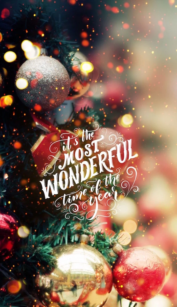 its the most wonderful time of the year written in white cursive christmas desktop wallpaper close up photo of decorated christmas tree