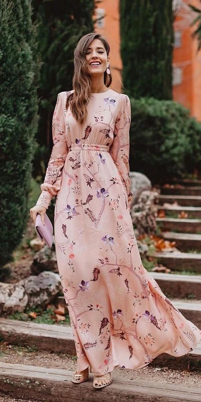 long sleeve wedding guest dresses long pink floral dress with long sleeves worn by woman with medium length brunette hair