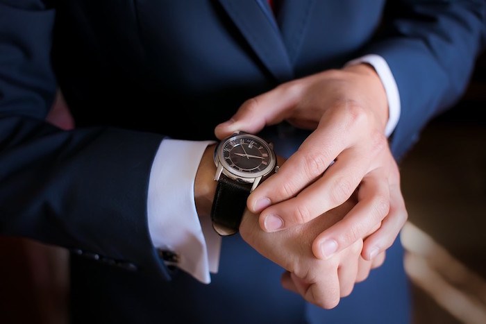 man wearing blue suit white shirt with cufflinks christmas gift ideas for dad watch with black leather strap