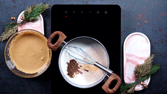 milk with cinnamon sticks brown sugar cooking on stove top alternative christmas dinner ideas bowl of egg mixture on the side