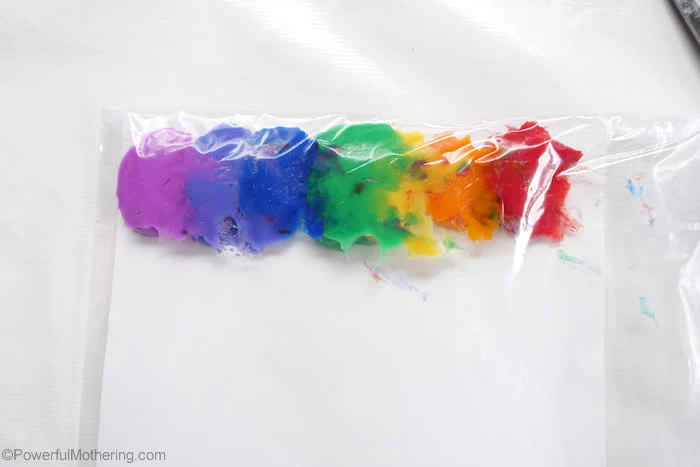 paint in all colors of the rainbow lined up on the bottom of ziploc bag placed on white surface things to do with kids at home