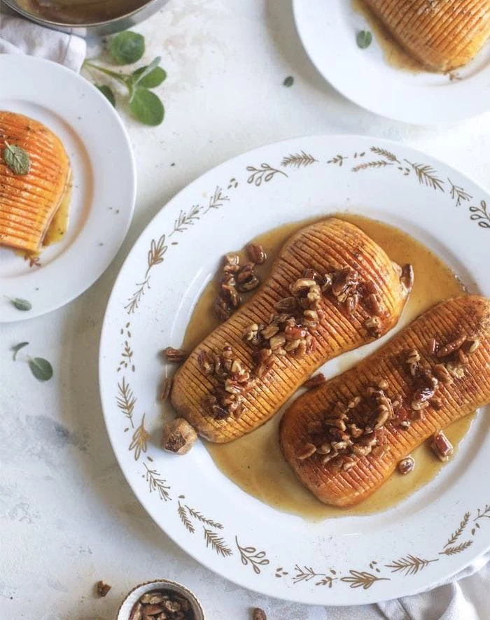 roasted butternut squash with honey cinnamon walnuts best thanksgiving sides placed on white plate on marble surface