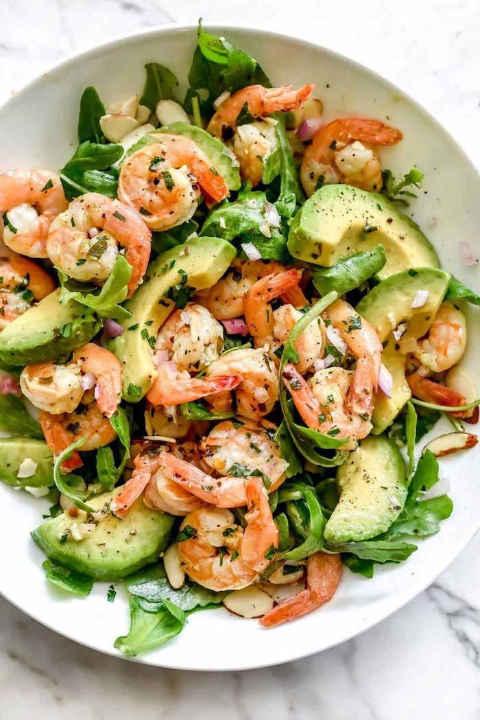 salad with arugula avocado onion silvered almonds shrimp cooked shrimp recipes in white plate