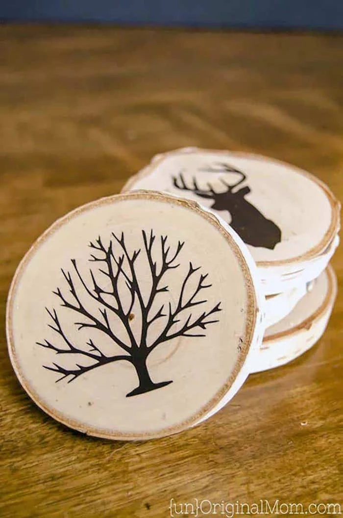 set of wood coasters with different drawings on them what to get dad for christmas arranged on wooden surface