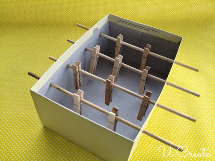 shoe box with wooden sticks inserted in it things to do with kids at home clothespins attached to the sticks