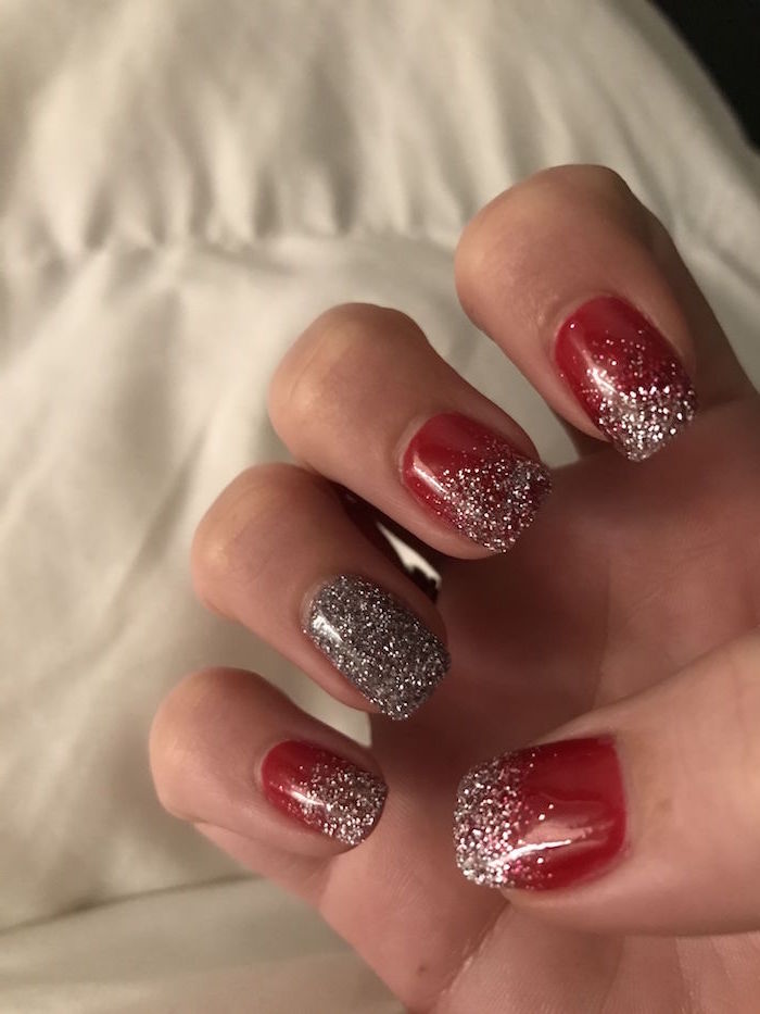 short squoval nails with red nail polish silver glitter on the tips christmas nail colors silver glitter on ring finger