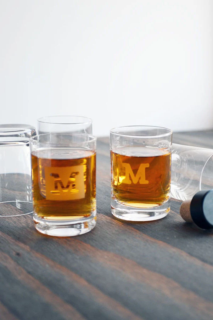 shot glasses personalised with initial best christmas gifts for dad placed on wood surface