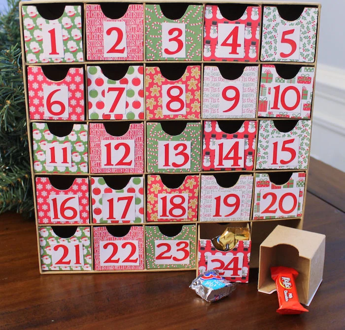 small carton boxes decorated with different christmas themed wrapping paper fun advent calendars candy in each box