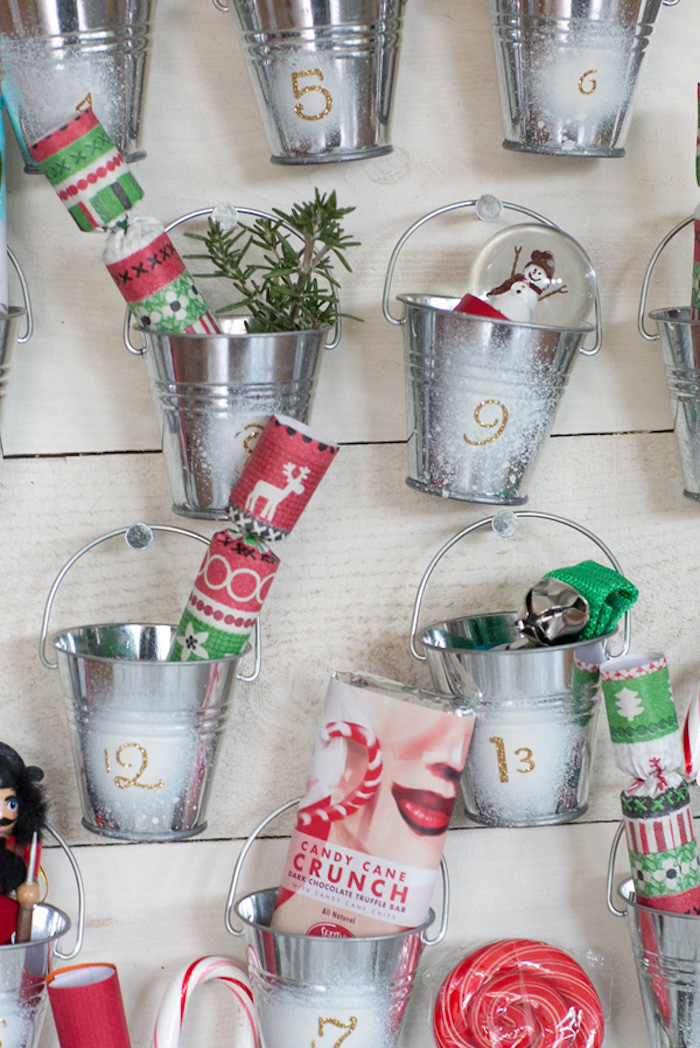 small metal buckets attached to wooden boards how to make an advent calendar filled with different items and candy