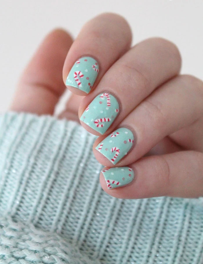 turquoise nail polish with candy cane decorations on short square nails christmas nail designs 2020