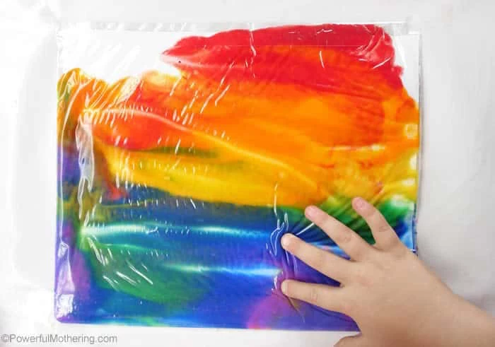 what to do on a rainy day no mess painting bag with paint in all colors of the rainbow placed on white surface