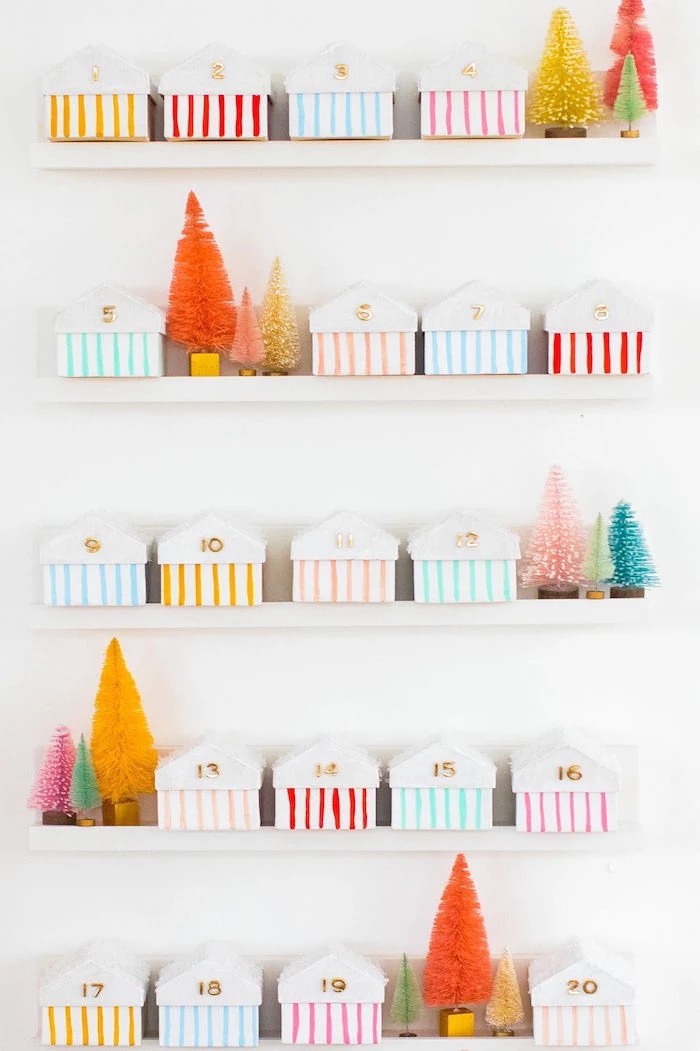 white wooden shelves mounted on white wall advent calendar ideas small boxes with numbers arranged on them with mini faux christmas trees