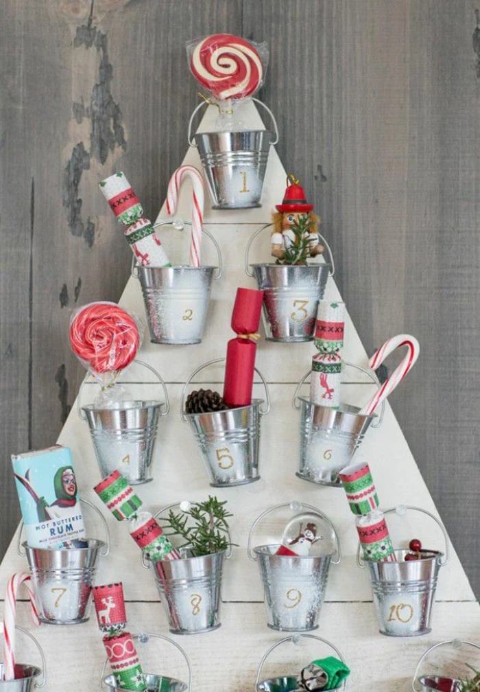 wooden boards in the shape of christmas tree how to make an advent calendar small metal buckets attached to it filled with candy