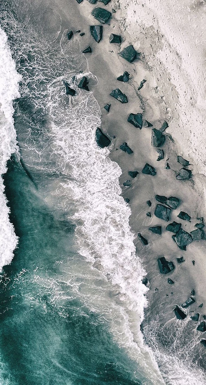 beach photographed from above minimalist phone wallpaper waves crashing into the rocks