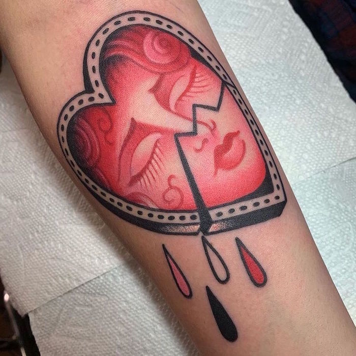 broken heart forearm tattoo heart tattoo on wrist red female face drawn inside drops of blood underneath