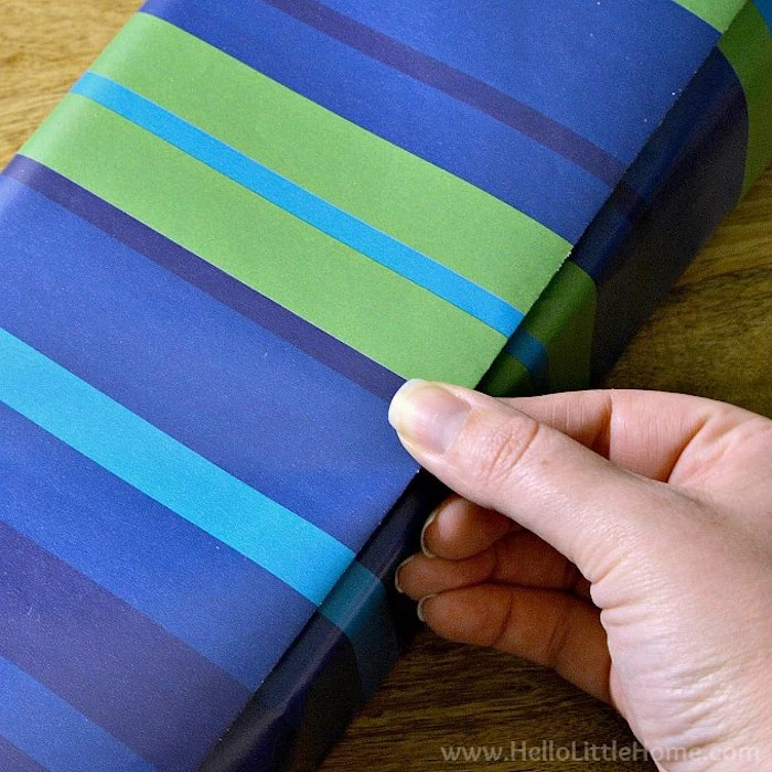 christmas gift wrapping ideas step by step diy tutorial made with wrapping paper in different shades of blue and green