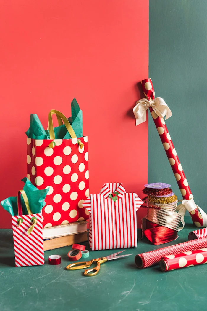 christmas presents arranged on green and red background how to wrap a gift wrapped with red and white wrapping paper and bags