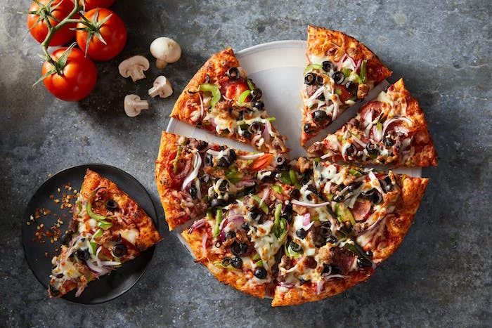 classic veggie pizza cut into slices homemade pizza recipe with onion mushrooms olives peppers