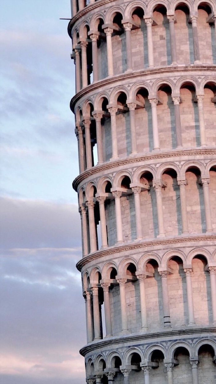 close up photo of the leaning tower of pisa minimalist desktop backgrounds sunset sky behind it