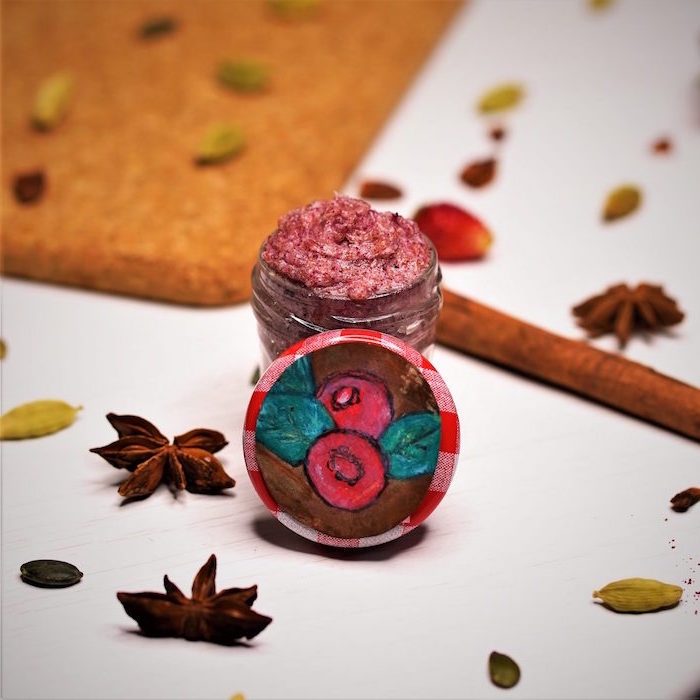 cranberries lip scrub diy lip scrub poured into small glass container star anise and cinnamon sticks around it