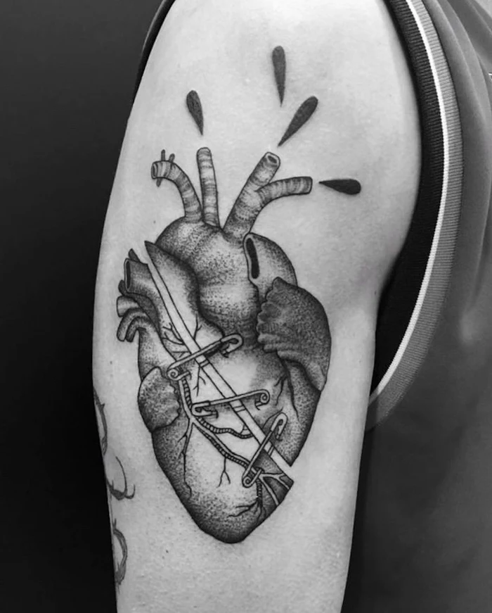 crying heart tattoo anatomically correct heart slashed in the middle held together with safety pins shoulder tattoo