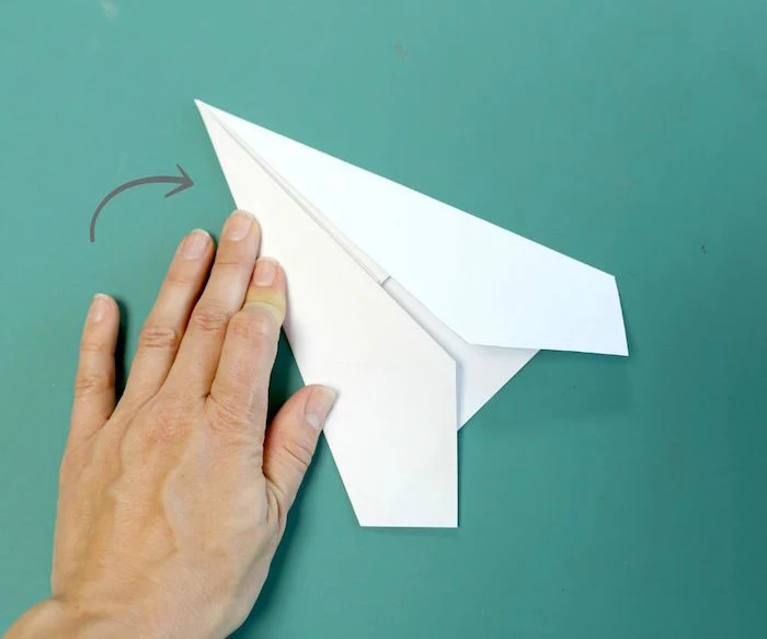 folding a piece of paper into a plane how to make a paper airplane easy step by step diy tutorial