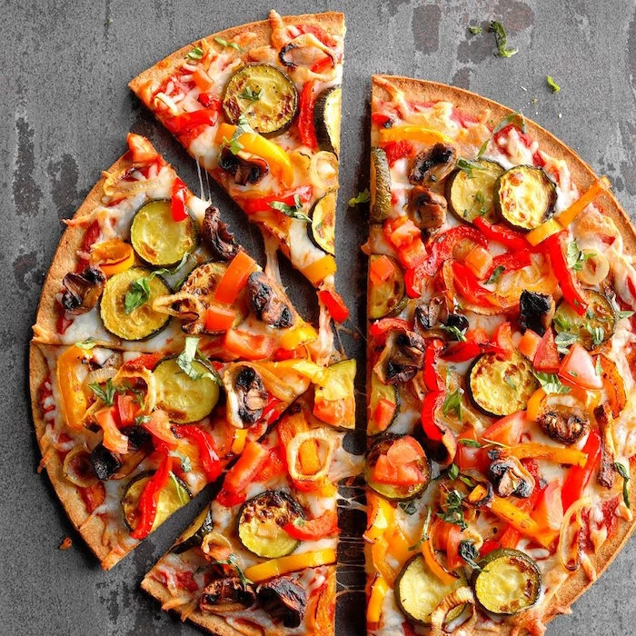 grilled veggie pizza with thin crust cut into slices homemade pizza dough with peppers mushrooms zucchini