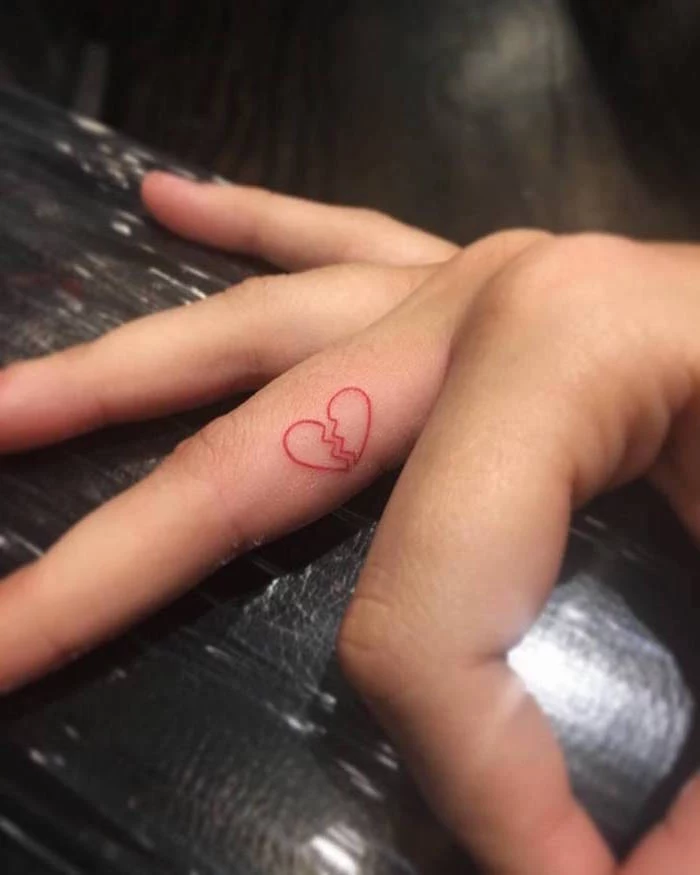 inside the finger tattoo crying heart tattoo red outline of heart broken in the middle