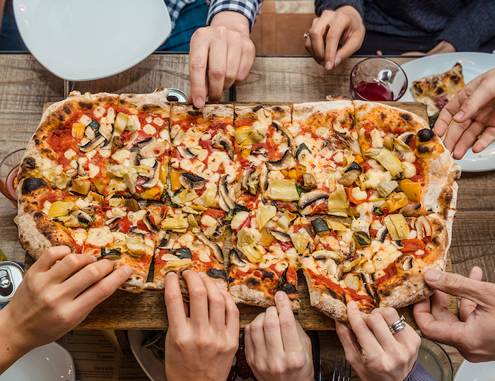 large rectangular pizza cut into slices best pizza dough recipe garnished with different vegetables mushrooms olives peppers onion