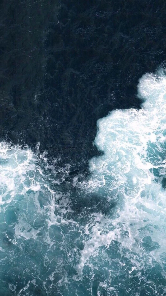 minimalist phone wallpaper blue aesthetic photo of waves crashing together in the dark waters