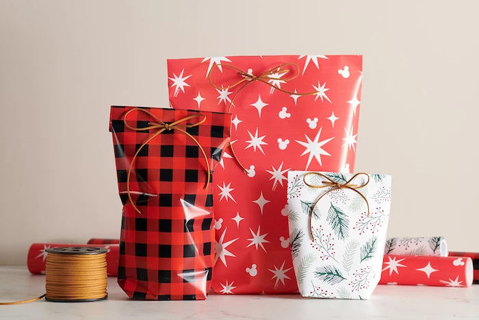 oddly shaped gifts wrapped in bags made from red and white wrapping paper how to wrap a present in bags