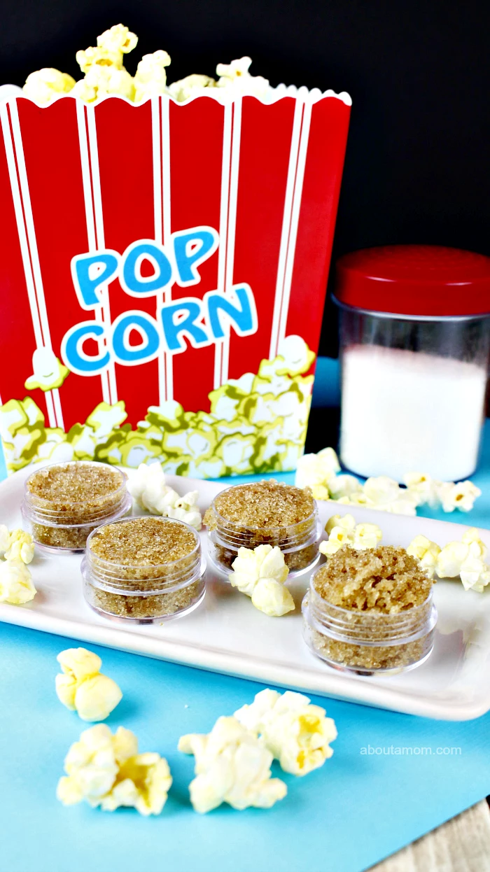 popcorn diy lip scrub in plastic container how to exfoliate lips popcorn scattered around it on white plate