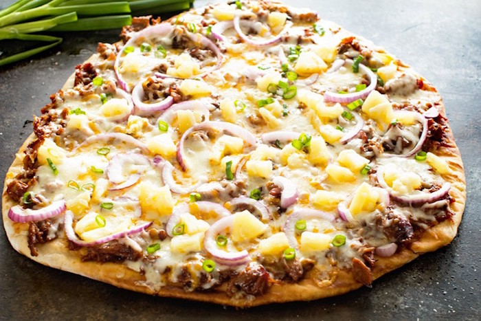 pulled pork pizza with onion lots of cheese thin crust pizza dough recipe placed on black surface