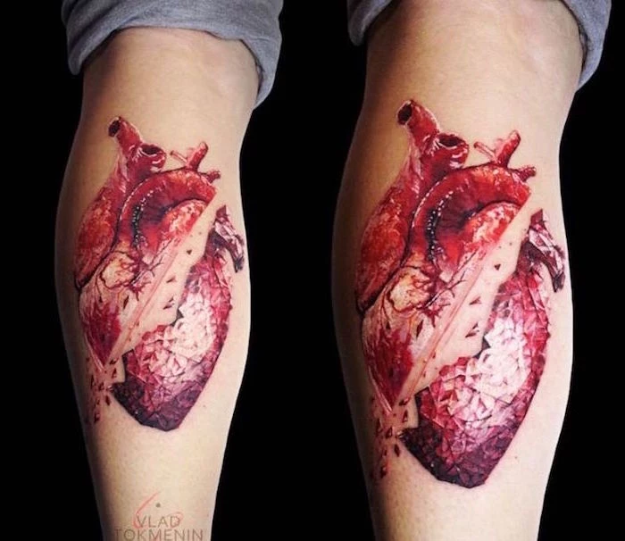 red anatomically correct heart slashed in the middle heart tattoo on wrist back of leg tattoo