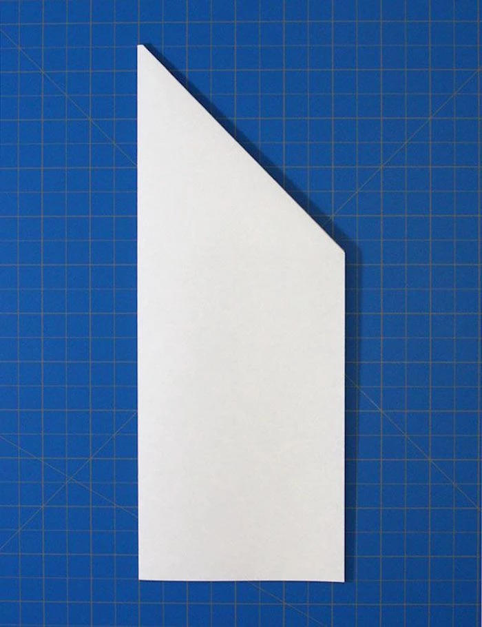 simple paper airplane white piece of paper placed on blue background being folded into plane