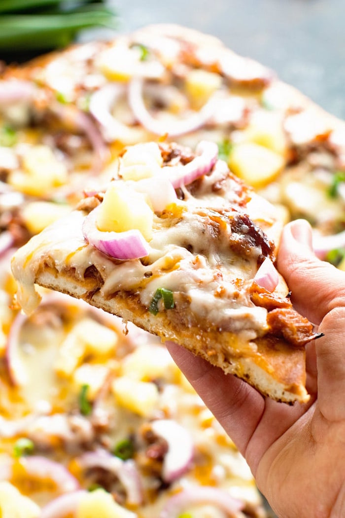 slice of pizza with pulled pork lots of cheese onion thin crust pizza dough recipe close up photo
