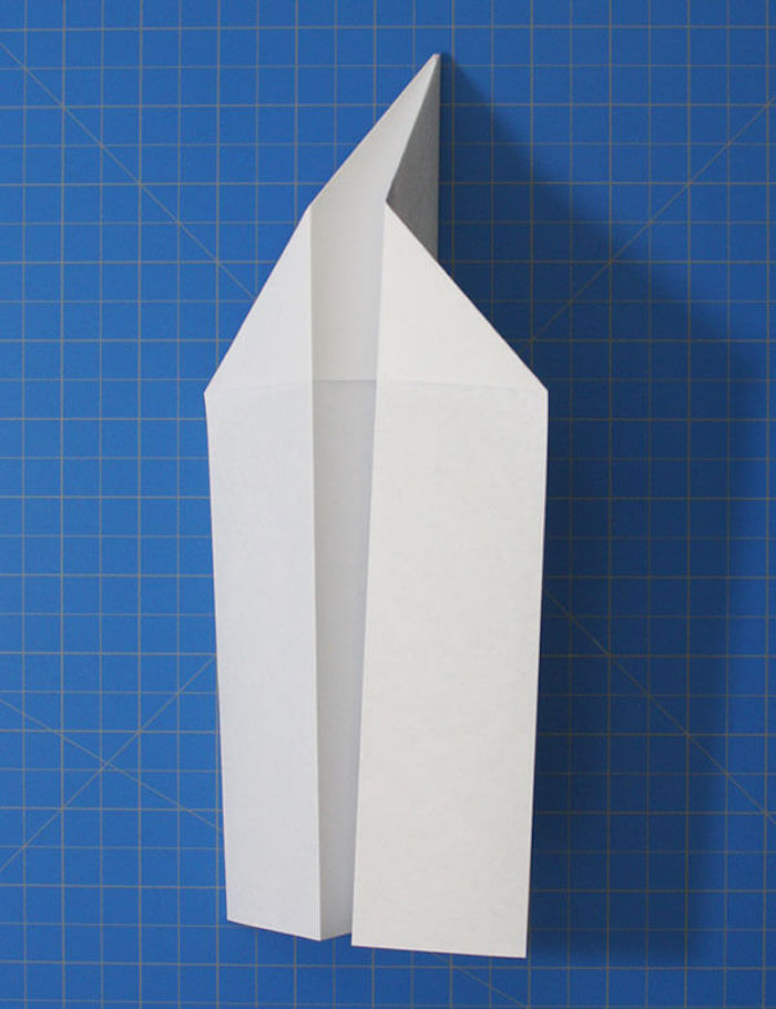 step by step diy tutorial for white piece of paper being folded into plane step by step paper airplane