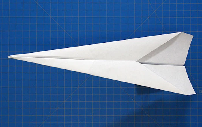 step by step diy tutorial how to make a paper airplane that flies far white piece of paper folded into plane