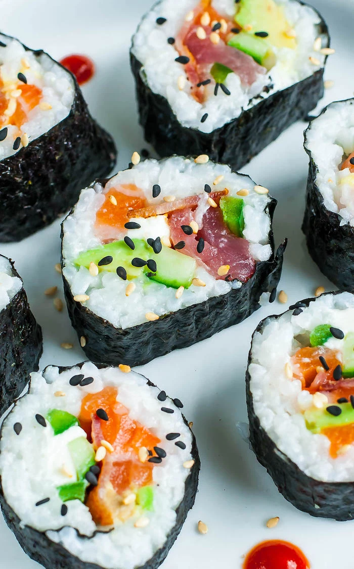 sushi with bacon avocado salmon black sesame seeds how to make sushi rice placed on white surface