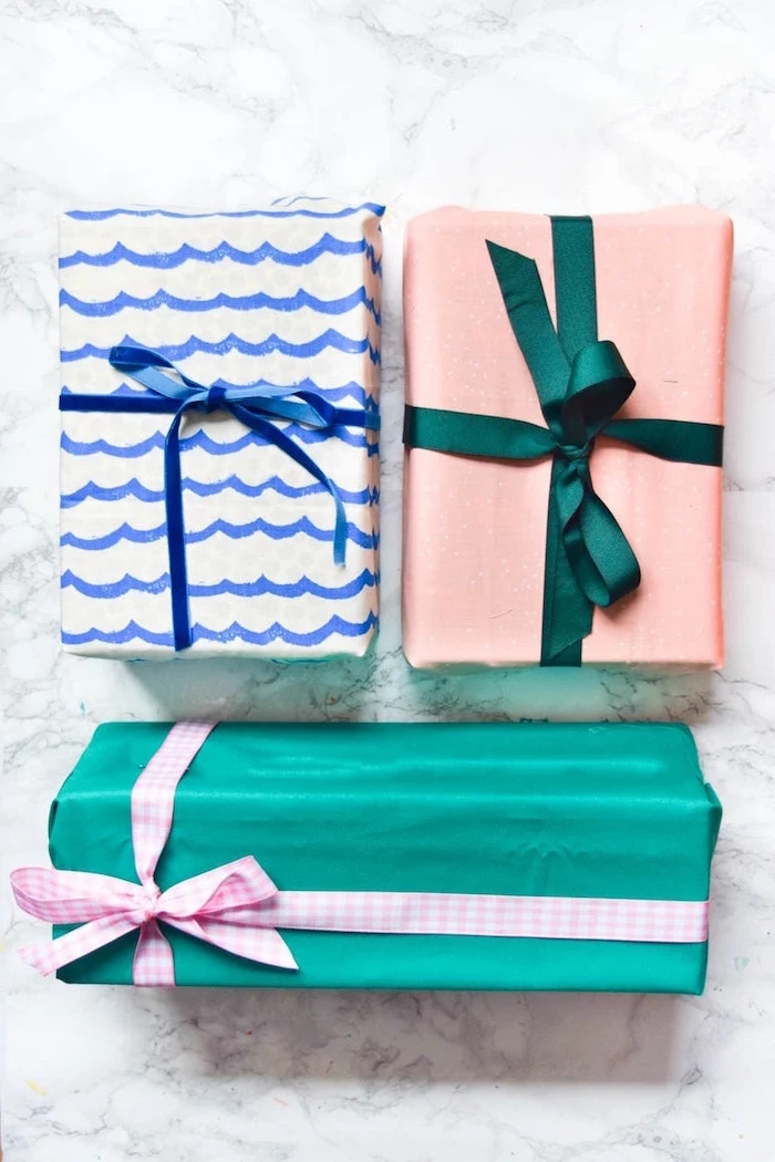three presents wrapped in fabric in turquoise blue white pink how to wrap a present wrapped with bows in pink green blue