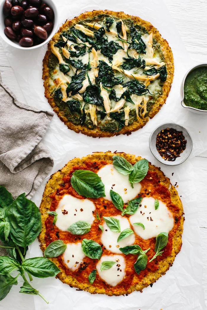 two mini pizzas with cauliflower crust easy pizza dough recipe one with chicken other with mozzarella and basil leaves